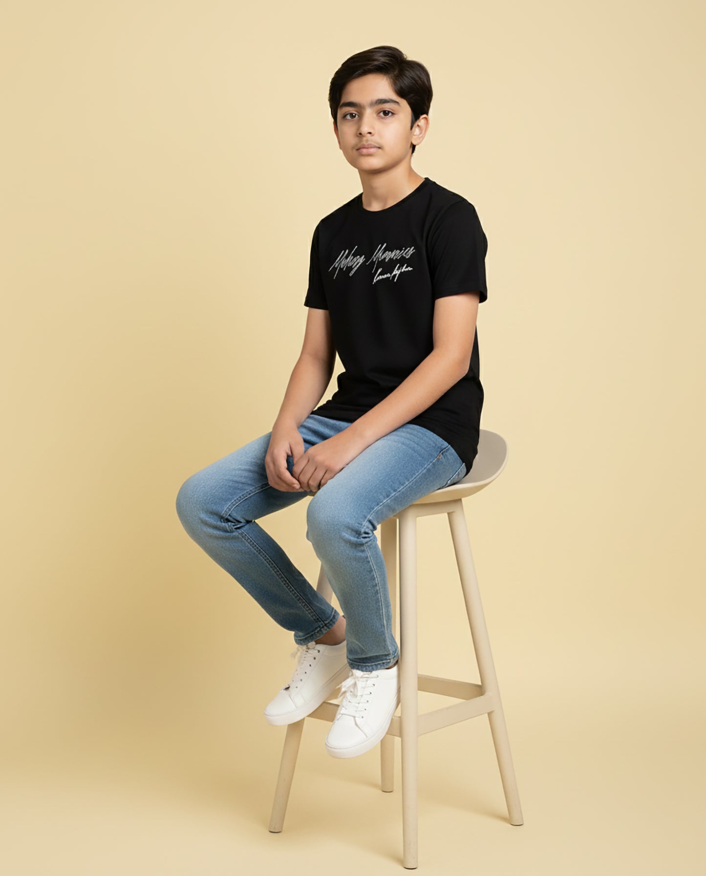 Kid wearing black “Making Memories” Karan Aujla kids unisex T-shirt with signature-style print