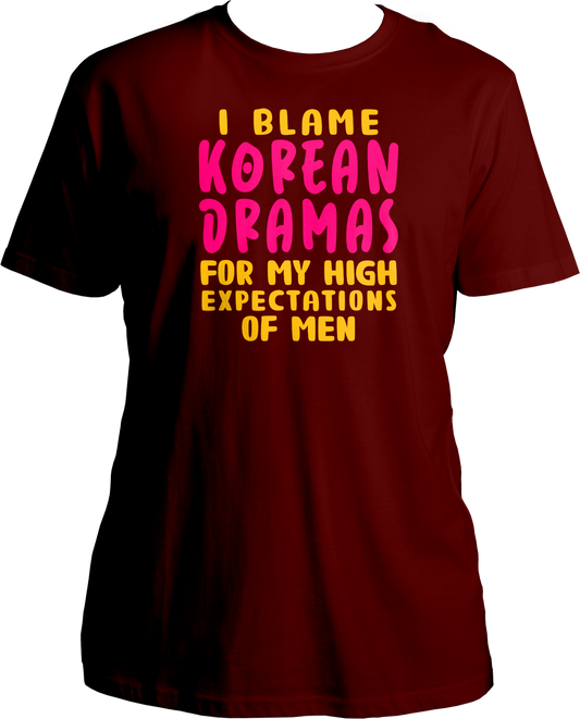 A trendy unisex t-shirt featuring the phrase "I Blame Korean Dramas For My High Expectations Of Men" printed on the front, perfect for female K-Drama fans.