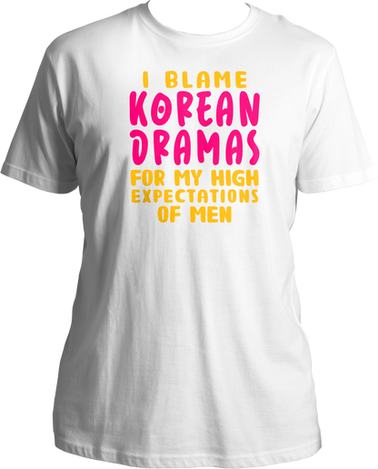 A trendy unisex t-shirt featuring the phrase "I Blame Korean Dramas For My High Expectations Of Men" printed on the front, perfect for female K-Drama fans.