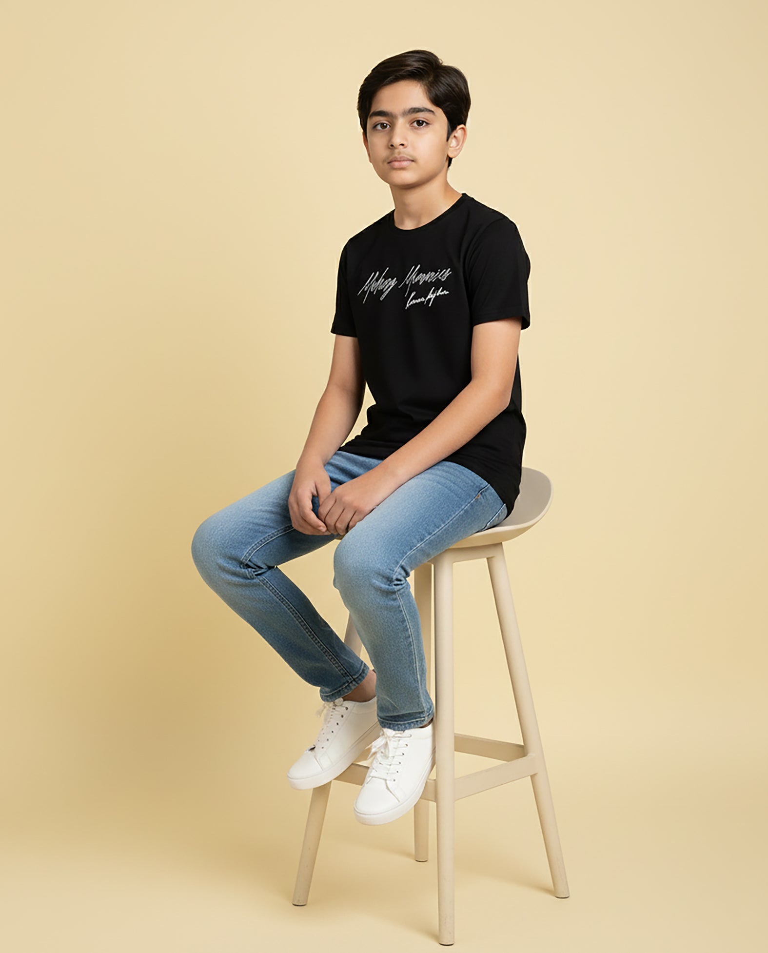 Kid wearing black “Making Memories” Karan Aujla kids unisex T-shirt with signature-style print