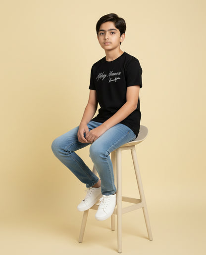 Kid wearing black “Making Memories” Karan Aujla kids unisex T-shirt with signature-style print
