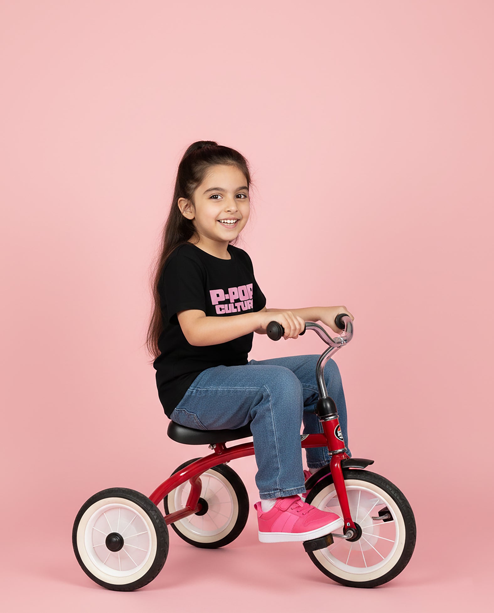 Girl wearing black P-Pop Culture Karan Aujla T-Shirt with pink block print – Garrari Kids Tee