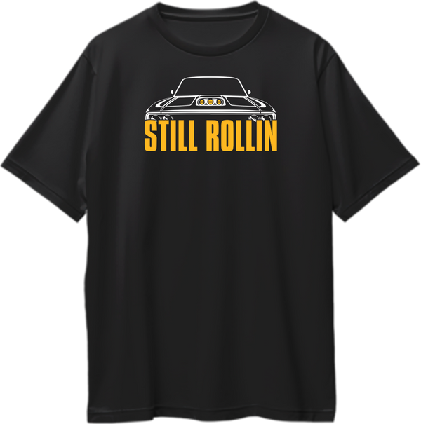 Black Still Rollin Oversized T-Shirt with white muscle car graphic and orange typography